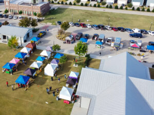 Top view colorful tents on grass lawn square at Farmer Market at 15